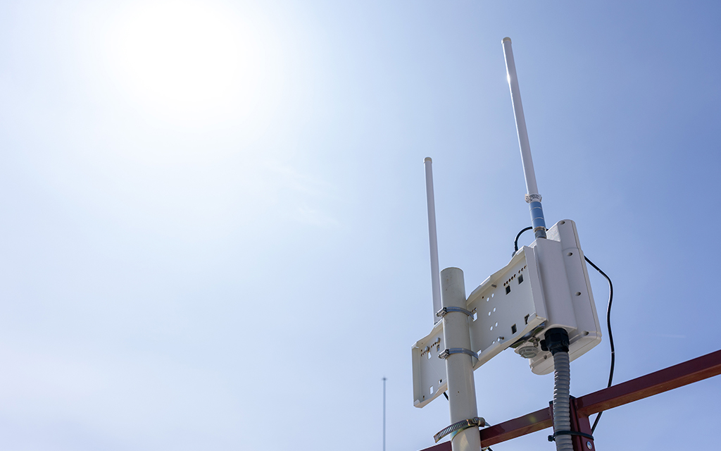 Outdoor antenna installation on a mast used for long-range wireless communications.